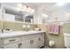 Bathroom with dual mirrors, long vanity and sink, drawers and cabinet space, towel rack and toilet at 105 Tranquility Dr, Villa Rica, GA 30180