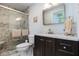 Bathroom featuring a walk-in tile shower with glass doors, vanity with sink, and toilet at 105 Tranquility Dr, Villa Rica, GA 30180