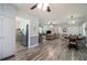 Open-concept living area with wood floors and natural light, seamlessly connecting the living room to the dining area at 105 Tranquility Dr, Villa Rica, GA 30180