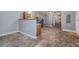 A large room with grey walls, tile floors, stainless refrigerator, and a door to the outside at 105 Tranquility Dr, Villa Rica, GA 30180