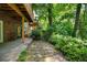 Back patio and stone pathway leads to lush backyard landscaping and private garden at 1203 Glenridge Ne Pl, Atlanta, GA 30342