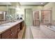 Beautiful bathroom with dual sinks, granite counters, tiled shower, and soaking tub at 1203 Glenridge Ne Pl, Atlanta, GA 30342