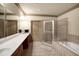 Bright bathroom features a large mirror, double sinks, and separate shower and soaking tub at 1203 Glenridge Ne Pl, Atlanta, GA 30342