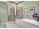 Bright bathroom boasts a tiled shower and luxurious soaking tub, perfect for relaxation at 1203 Glenridge Ne Pl, Atlanta, GA 30342