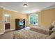Bedroom featuring twin beds, a large window, a TV cabinet, and access to an en-suite bathroom at 1203 Glenridge Ne Pl, Atlanta, GA 30342