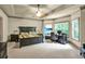 Large main bedroom features a ceiling fan, tv, and an adjacent desk area at 1203 Glenridge Ne Pl, Atlanta, GA 30342