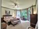 Spacious main bedroom features a sitting area, ceiling fan, and large windows providing natural light at 1203 Glenridge Ne Pl, Atlanta, GA 30342