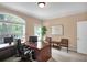 Home office space with large arched window, plush carpeting, and stylish furnishings at 1203 Glenridge Ne Pl, Atlanta, GA 30342