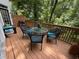 Outdoor patio with seating surrounded by lush greenery and a wooded backdrop at 1203 Glenridge Ne Pl, Atlanta, GA 30342