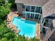 Overhead view of a sparkling pool with lush landscaping and multi-story balconies at 1203 Glenridge Ne Pl, Atlanta, GA 30342