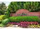 Elegant community entrance with brick signage and lush landscaping for Glenridge Creek Townhomes at 1203 Glenridge Ne Pl, Atlanta, GA 30342