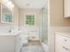 Bright bathroom featuring a glass shower, vanity, modern fixtures, and wainscoting at 175 Smith Ferguson Rd, Dallas, GA 30157