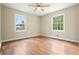 Bright bedroom with hardwood floors, ceiling fan, and two windows for ample natural light at 175 Smith Ferguson Rd, Dallas, GA 30157