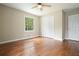 Bedroom with hardwood floors, ceiling fan, double closets, and window overlooking trees at 175 Smith Ferguson Rd, Dallas, GA 30157