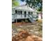 Charming one-story home featuring a covered front porch, American flag, and landscaped front yard at 175 Smith Ferguson Rd, Dallas, GA 30157