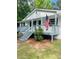 Charming home featuring front porch with American flag waving, creating a patriotic welcome at 175 Smith Ferguson Rd, Dallas, GA 30157