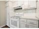 Well-equipped kitchen with white cabinets, modern appliances, and sleek countertops, ready for culinary adventures at 175 Smith Ferguson Rd, Dallas, GA 30157