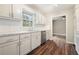 Well-lit kitchen featuring white cabinets, modern appliances, and a seamless connection to adjacent rooms at 175 Smith Ferguson Rd, Dallas, GA 30157