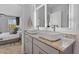 Bright bathroom featuring double vessel sinks and modern fixtures with a glimpse into bedroom at 229 Ivey Ter, Temple, GA 30179