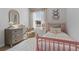 Bright bedroom with a pink bed, patterned rug, and window at 229 Ivey Ter, Temple, GA 30179