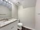 Bathroom featuring a granite vanity top, white cabinets, and contemporary fixtures at 3508 Sweetgum Ln, Decatur, GA 30032