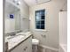 Modern bathroom with granite countertop, white cabinet, and combined shower-tub at 3508 Sweetgum Ln, Decatur, GA 30032