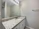 Bathroom featuring granite countertop, white cabinets, and a shower/tub with neutral wall color at 3508 Sweetgum Ln, Decatur, GA 30032
