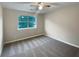 Clean and simple bedroom featuring a window and neutral tones, offering a relaxing retreat at 3508 Sweetgum Ln, Decatur, GA 30032