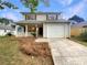 Charming two-story home with a well-maintained front yard and covered porch, and a single-car garage at 3508 Sweetgum Ln, Decatur, GA 30032