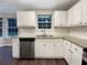 Modern kitchen featuring white cabinets, granite countertops, stainless steel appliances, and a window at 3508 Sweetgum Ln, Decatur, GA 30032