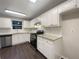 Bright kitchen with white cabinets, granite countertops, stainless steel appliances, and dark flooring at 3508 Sweetgum Ln, Decatur, GA 30032