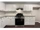 Well-equipped kitchen boasts stainless steel appliances, white cabinets, subway tile backsplash, and granite countertops at 3508 Sweetgum Ln, Decatur, GA 30032