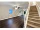 Spacious living room with dark floors and staircase, offering a seamless flow for entertaining at 3508 Sweetgum Ln, Decatur, GA 30032