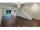 Open-concept living space with dark flooring and staircase, offering a seamless flow for entertaining at 3508 Sweetgum Ln, Decatur, GA 30032