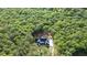 Overhead shot of the modern farmhouse surrounded by mature trees and greenery at 5567 Tyree Rd, Winston, GA 30187