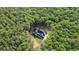 An aerial view of a home nestled amongst a canopy of green trees at 5567 Tyree Rd, Winston, GA 30187