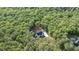 Stunning aerial view of a modern home nestled in lush green trees at 5567 Tyree Rd, Winston, GA 30187