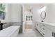 Bright bathroom boasts double vanities, a freestanding tub, and backyard views at 5567 Tyree Rd, Winston, GA 30187