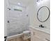 Modern bathroom with tiled shower, toilet, and marble top vanity sink at 5567 Tyree Rd, Winston, GA 30187