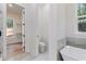 A stylish bathroom with a soaking tub and large windows overlooking the wooded lot at 5567 Tyree Rd, Winston, GA 30187