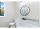 Bathroom with white vanity, round mirror, and glass shower at 5567 Tyree Rd, Winston, GA 30187