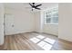 Bedroom with light, wood-look floors, large window and contemporary ceiling fan at 5567 Tyree Rd, Winston, GA 30187