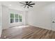 A bright bedroom featuring a ceiling fan, large windows and hardwood floors at 5567 Tyree Rd, Winston, GA 30187