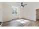 Bedroom bathed in sunlight, featuring stylish wood flooring and modern ceiling fan at 5567 Tyree Rd, Winston, GA 30187