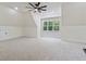 Cozy bedroom space with a ceiling fan, carpet, and plenty of natural light at 5567 Tyree Rd, Winston, GA 30187