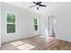 Bright, airy bedroom with wood floors and a view of the surrounding trees at 5567 Tyree Rd, Winston, GA 30187