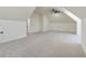 Spacious, light-filled bonus room features neutral carpeting and modern ceiling fan at 5567 Tyree Rd, Winston, GA 30187