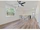 Bonus room with high ceilings, large windows, ceiling fan, and hardwood floors at 5567 Tyree Rd, Winston, GA 30187
