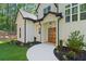 Charming home entrance featuring a curved walkway, manicured landscaping, and a striking front door at 5567 Tyree Rd, Winston, GA 30187