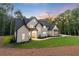 Charming modern farmhouse with black trim surrounded by lush greenery and a large yard at 5567 Tyree Rd, Winston, GA 30187